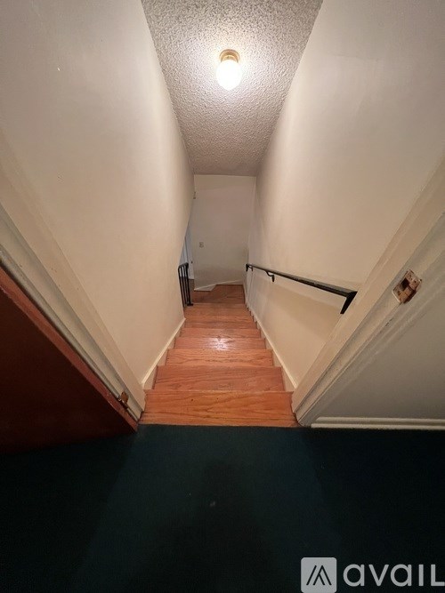 A long hallway with a light on the ceiling.