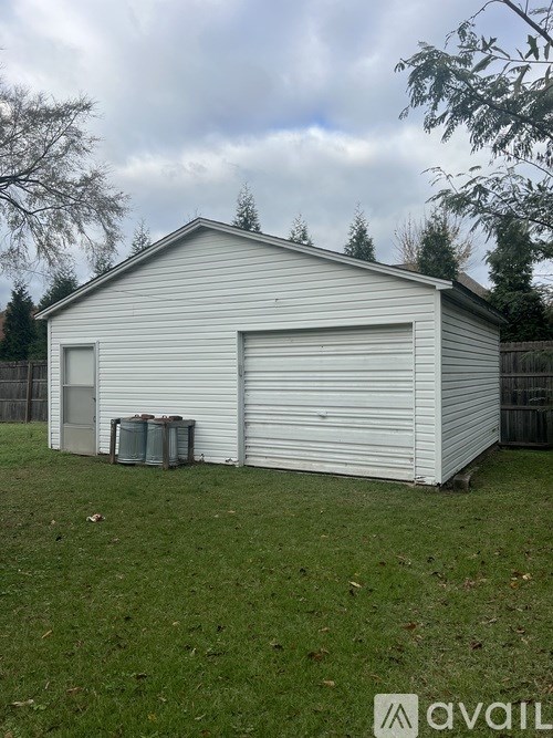 A white garage with a closed door and a closed window.