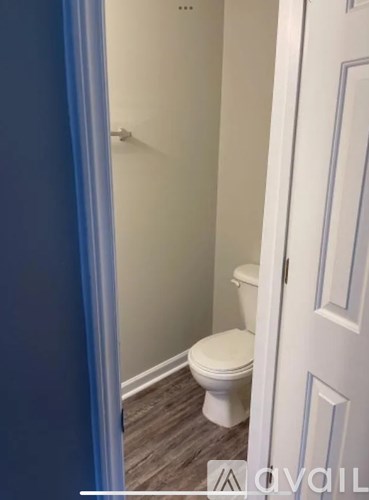 A white toilet in a small bathroom.