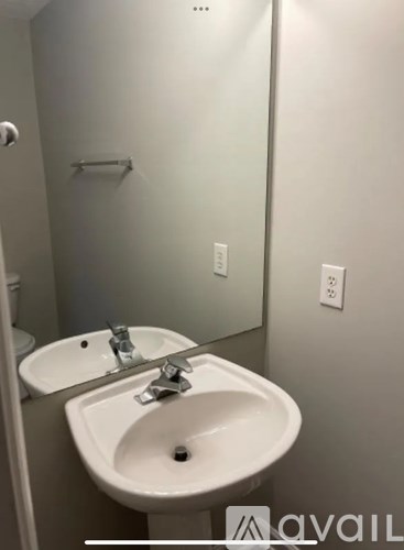 A white sink with a silver faucet in a bathroom.
