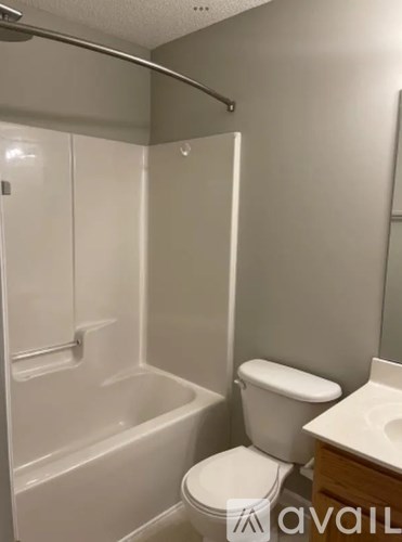 A bathroom with a toilet, sink, and bathtub.