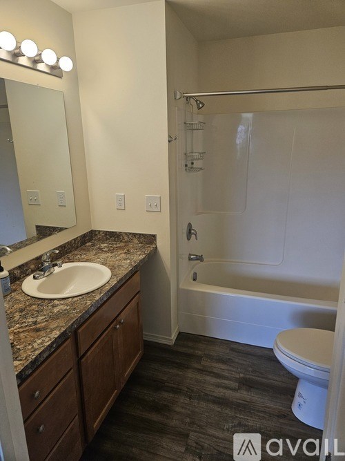 A bathroom with a sink, toilet, and bathtub.