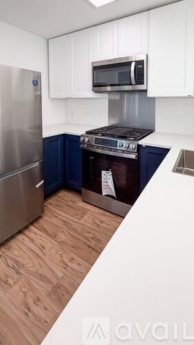 A kitchen with a stove top oven and a refrigerator.