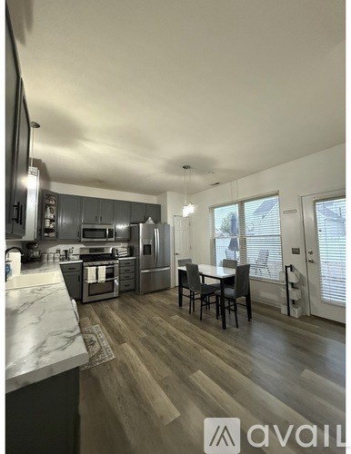 A modern kitchen with a dining table and chairs.
