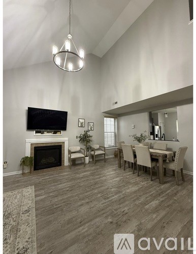 A living room with a fireplace and a television.