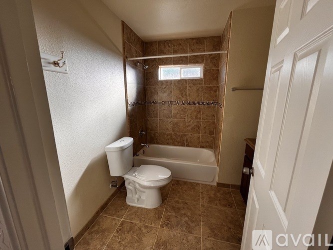 A bathroom with a toilet, tub, and shower.