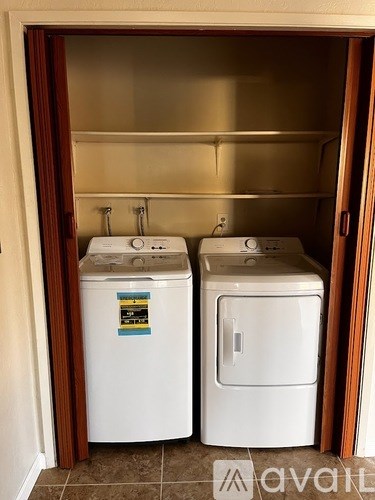 A small laundry room with a washer and dryer.
