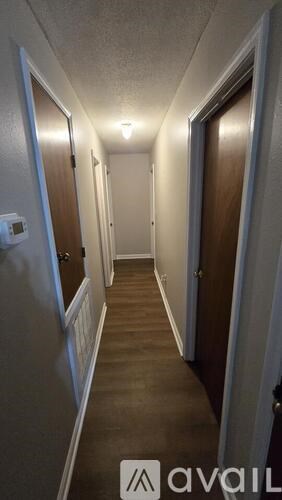 A long hallway with doors on both sides.