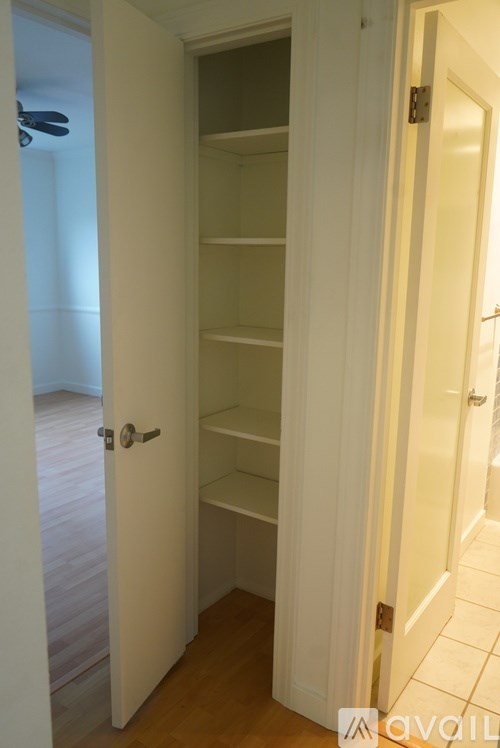 A white door is open to a hallway.