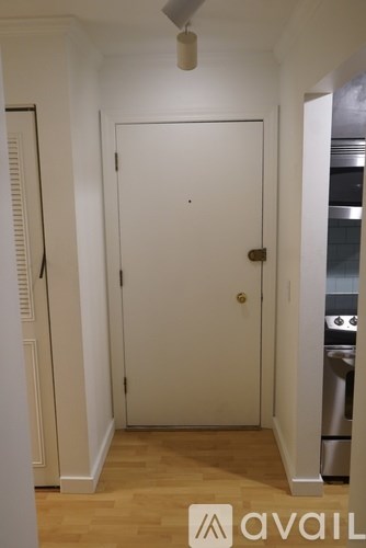 A white door in a room with wooden flooring and a logo that says "avail" on the bottom right.