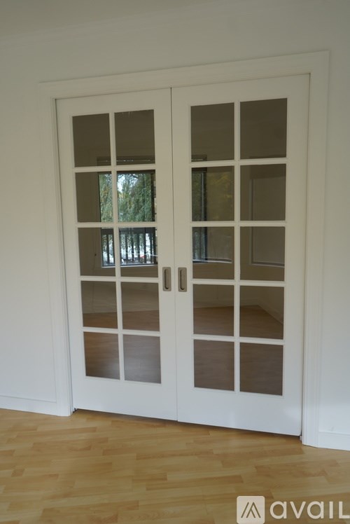 A white double door with glass panels and a handle.