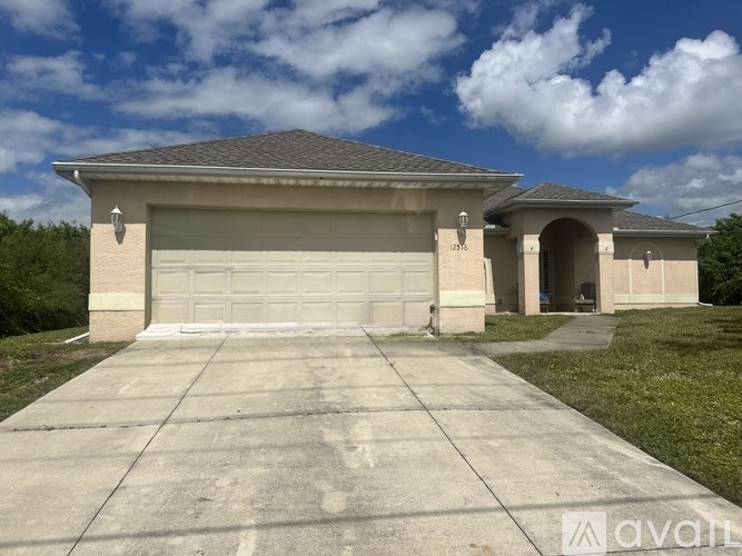 A house with a garage is for sale.