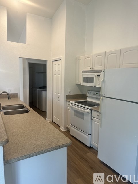 A kitchen with white appliances and a countertop.