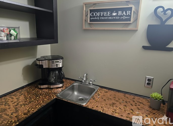 A coffee bar with a coffee machine and a sign that says "Coffee & Bar".