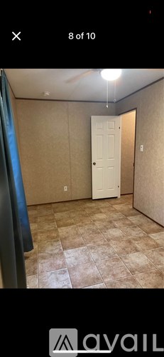 A room with beige walls and a white door.