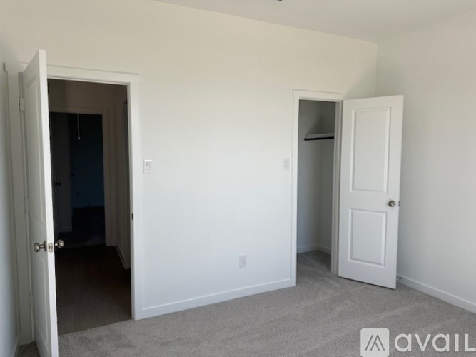 A room with two doors, one of which is open.