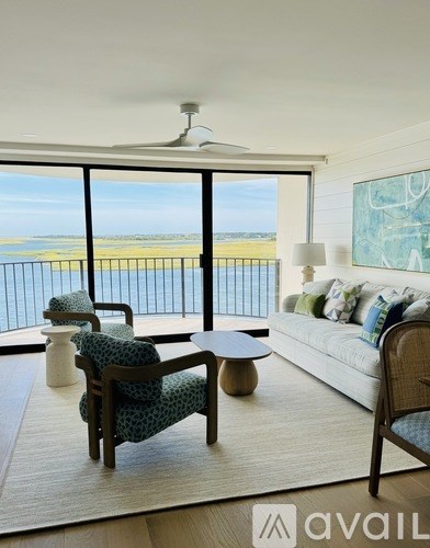 A living room with a view of the beach.