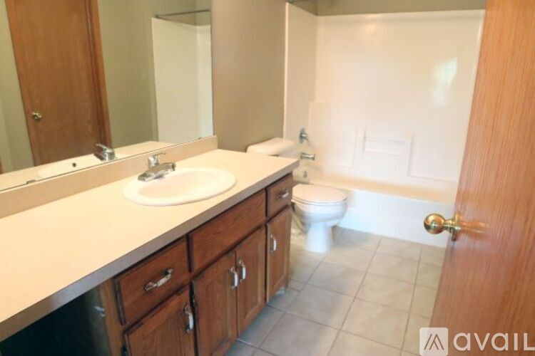A bathroom with a sink, toilet, and bathtub.