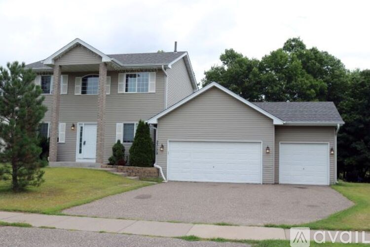 A house with a grey roof and a white garage door.