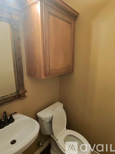 A white toilet sits next to a sink in a bathroom.
