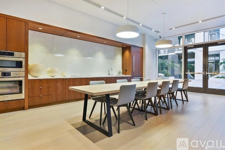 A modern kitchen with a dining table and chairs.