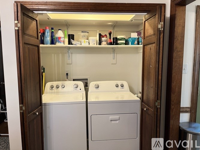 A small laundry room with a washer and dryer.
