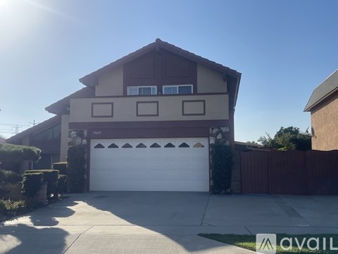 A house with a garage and a driveway in front.