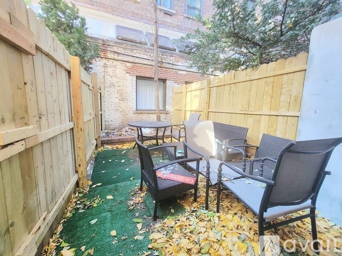 A small backyard with a table and chairs.
