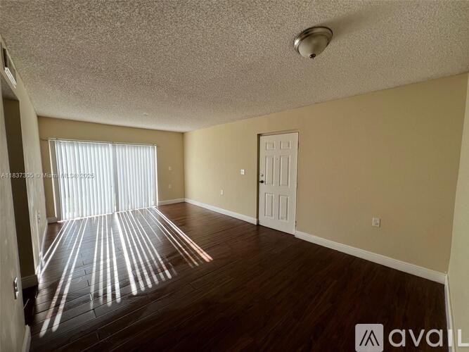 A room with wooden floors and a white door.