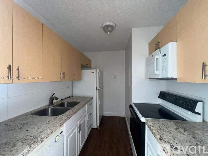 A kitchen with wooden cabinets and granite countertops.