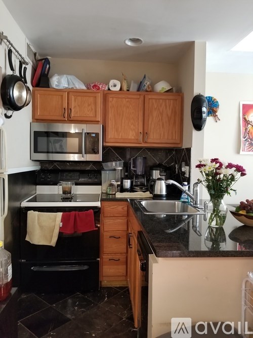 A kitchen with a black oven and a black microwave.