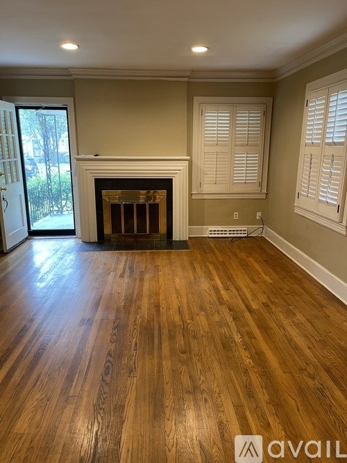 A room with wooden floors and a fireplace.