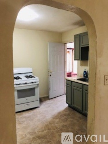 A kitchen with a stove and a refrigerator.