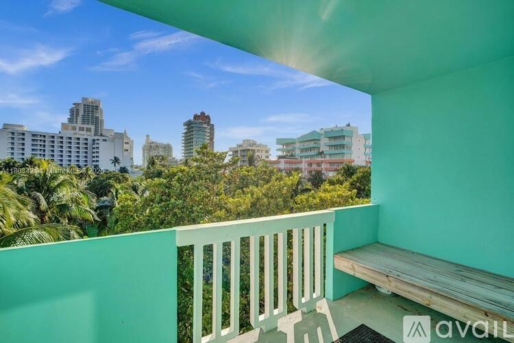 A balcony with a bench overlooks a cityscape.