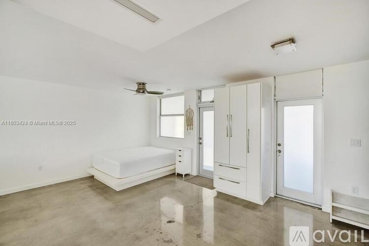 A bedroom with a bed, dresser, and mirror.