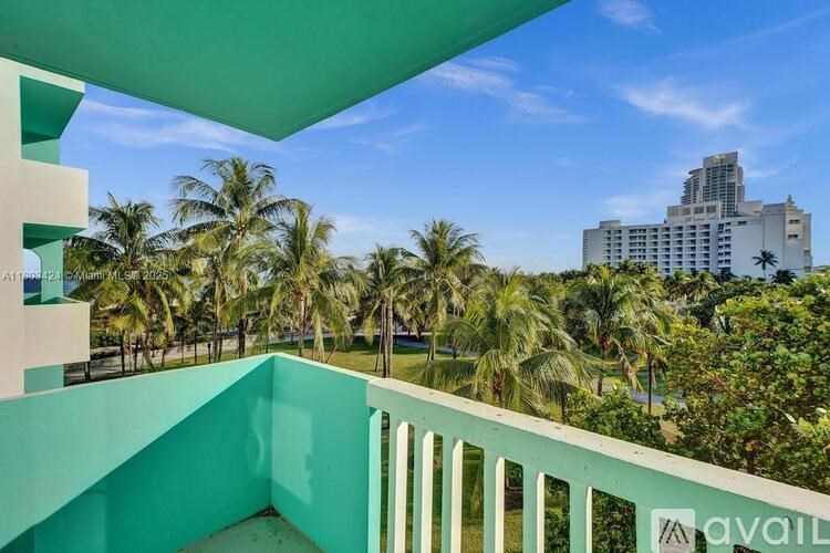 A balcony with a view of palm trees and buildings.