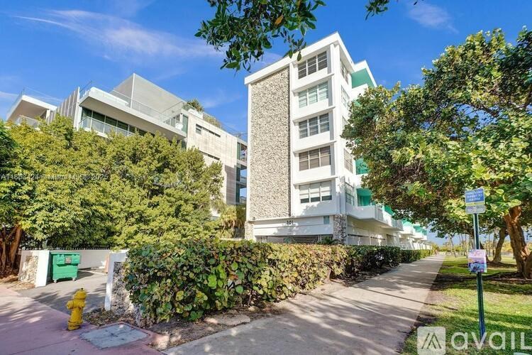 A modern building with a green lawn in front.