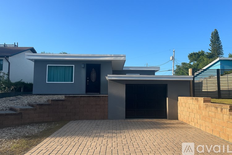 A modern house with a garage and a driveway.
