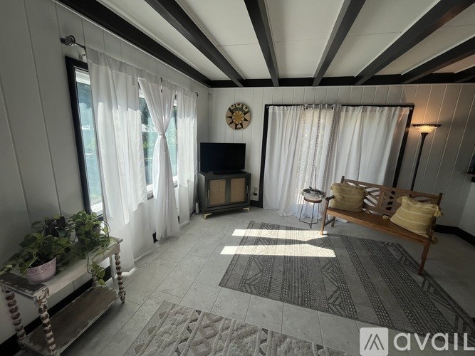 A living room with a fireplace, a sofa, and a clock on the wall.