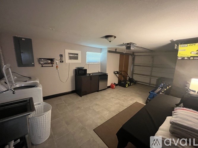 A room with a washing machine and a dryer.