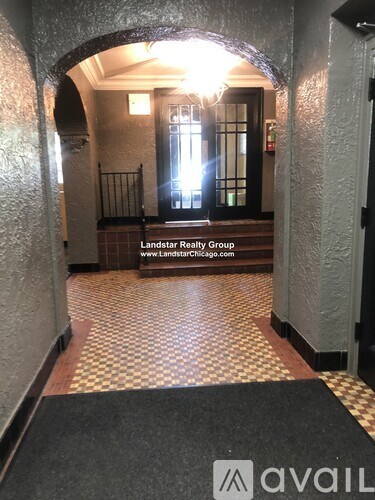 A hallway with a checkered floor and a sign for Landstar Realty Group.
