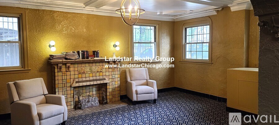 A living room with a fireplace and two chairs.