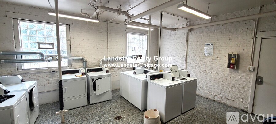 A white brick wall with a window and a washing machine.