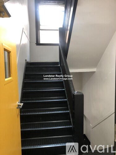A staircase with a Landstar Realty Group sign on the wall.
