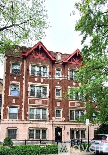 A red brick building with a black door and windows.