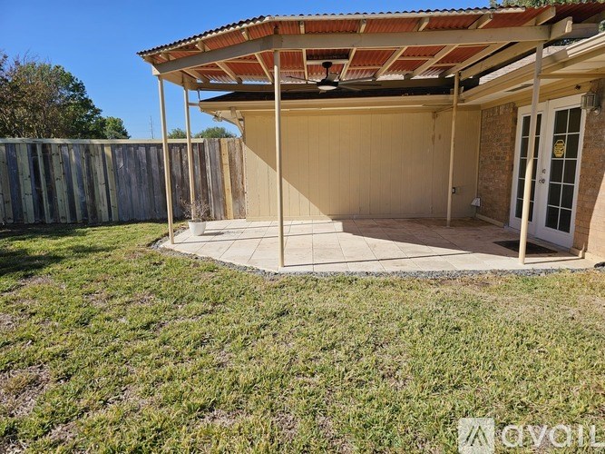 A patio area with a roof and a door is visible.