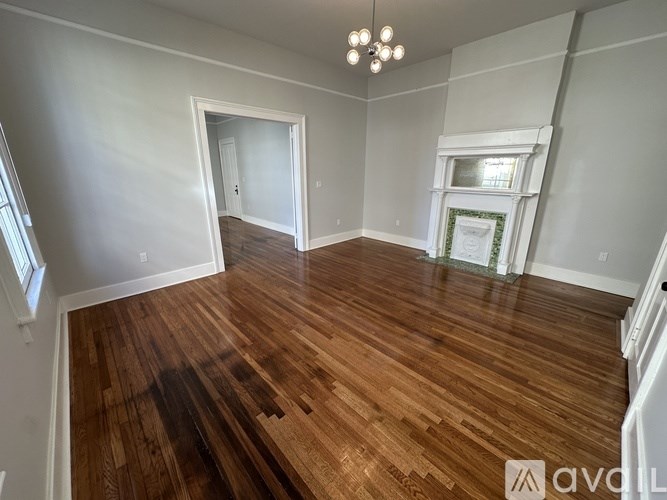 A room with wooden floors and a fireplace.