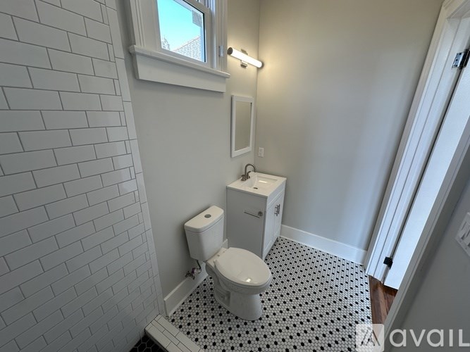 A bathroom with a toilet and a sink.
