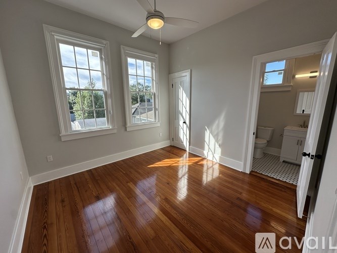 A room with wooden floors and a ceiling fan.
