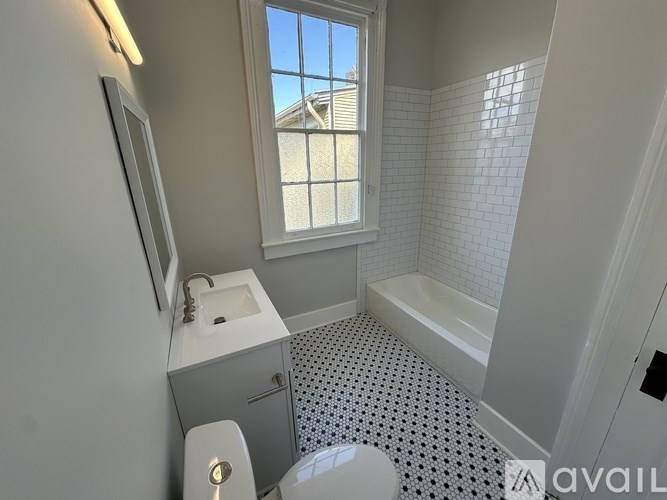 A bathroom with a toilet, sink, and bathtub.